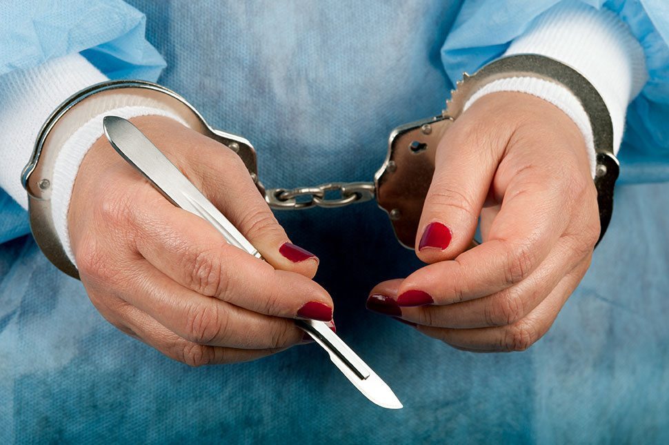 stock-photo-35227120-criminal-handcuffed-medical-person-with-lancet-scalpel-in-hand
